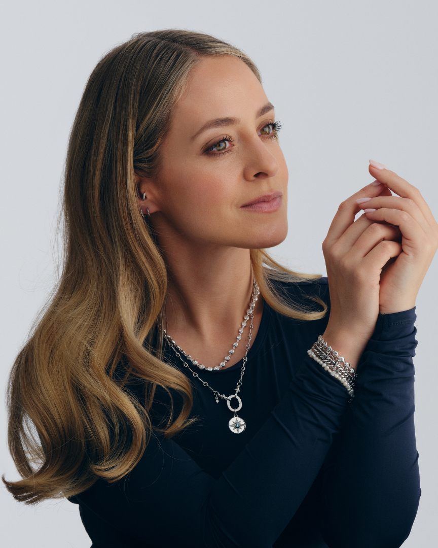 Fleur De Force wearing layered silver necklaces with Vega pendant, pearl and dusk bracelets Raven James jewellery stack