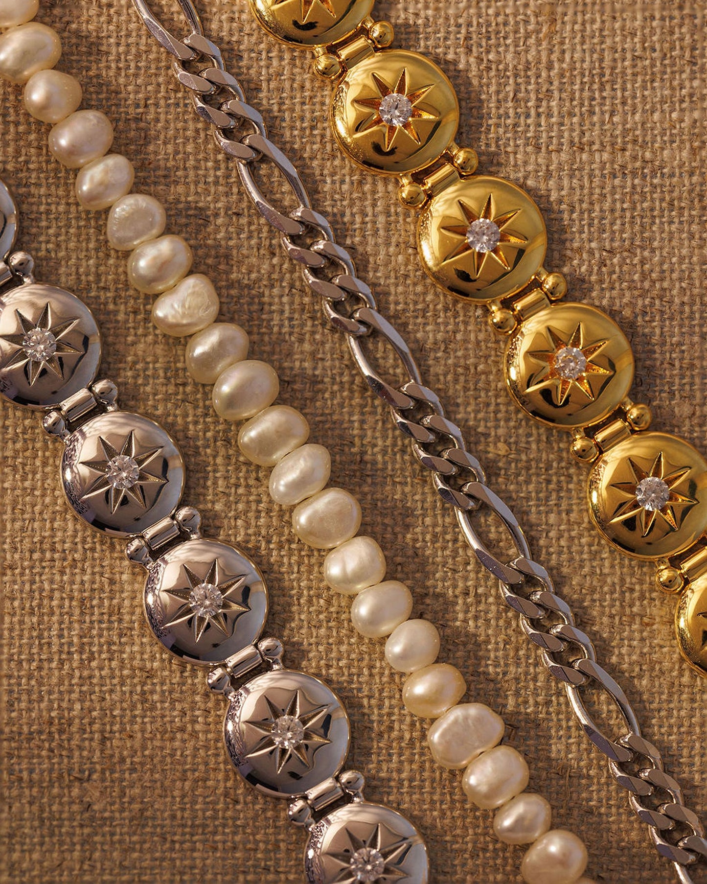 Mixed metal bracelet stack with gold, silver, pearl and chain bracelets layered together