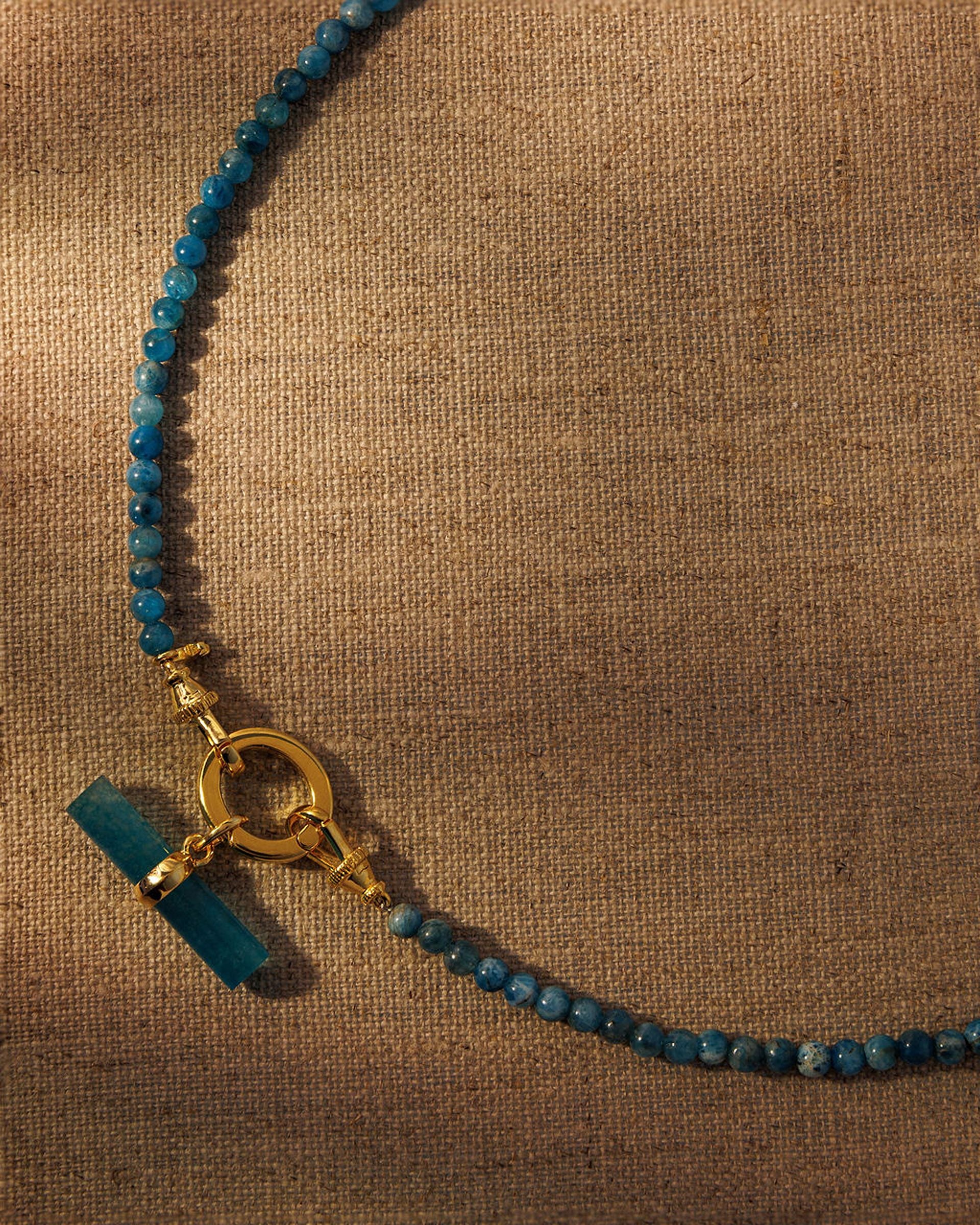 Apatite beaded necklace with gold oval clasp and teal T-bar pendant attached