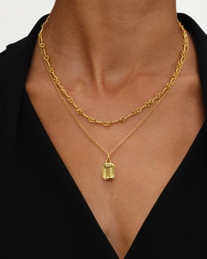 Layered gold necklaces with lemon quartz pendant on Ivy chain and Arabella horse bit chain