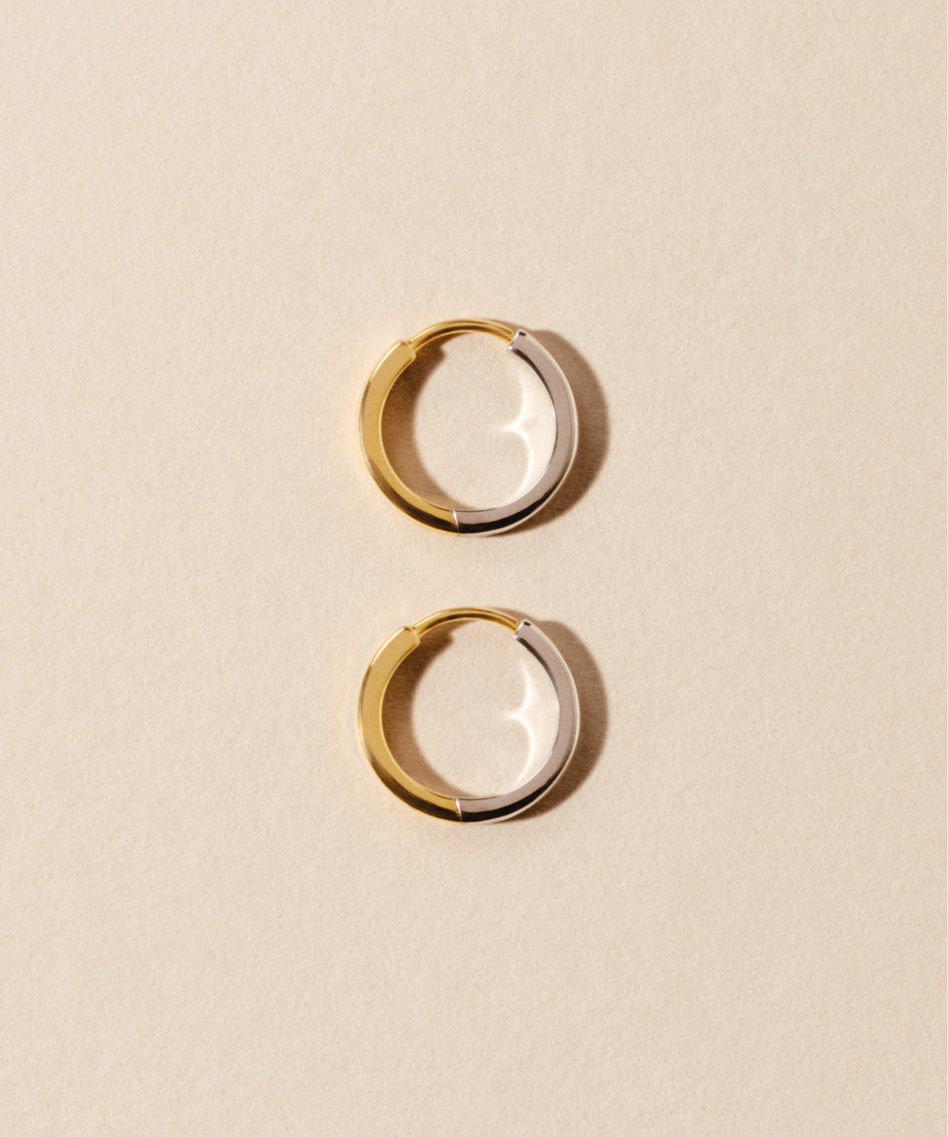 large Cara reversible huggie hoops in mixed metal gold and silver