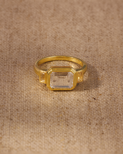 Clear quartz emerald cut ring in gold vermeil bezel setting with baguette side stones