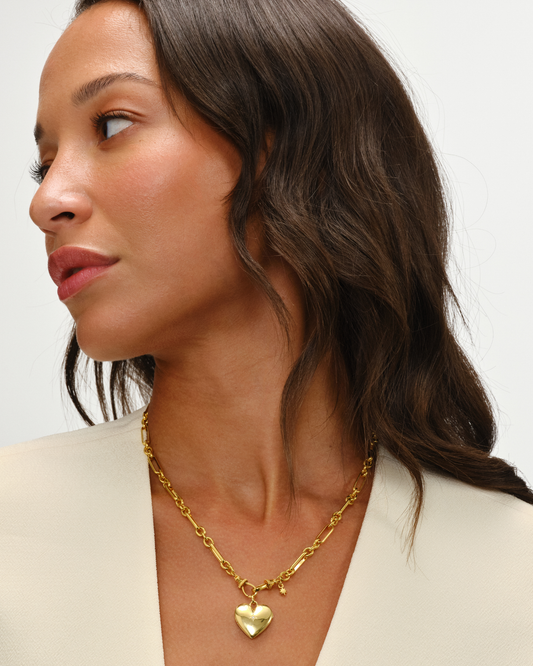 Cora Gold heart locket pendant on Tabitha trombone link chain necklace with oval clasp detail