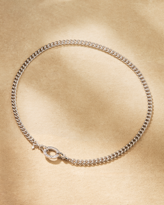 Silver curb chain necklace with oval clasp designed for attaching pendants and connecting to other chains