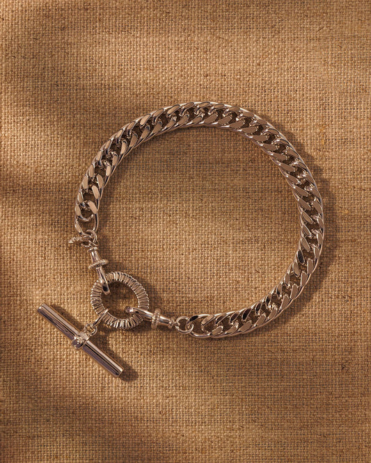 Silver chain bracelet with T-bar pendant attached to oval clasp