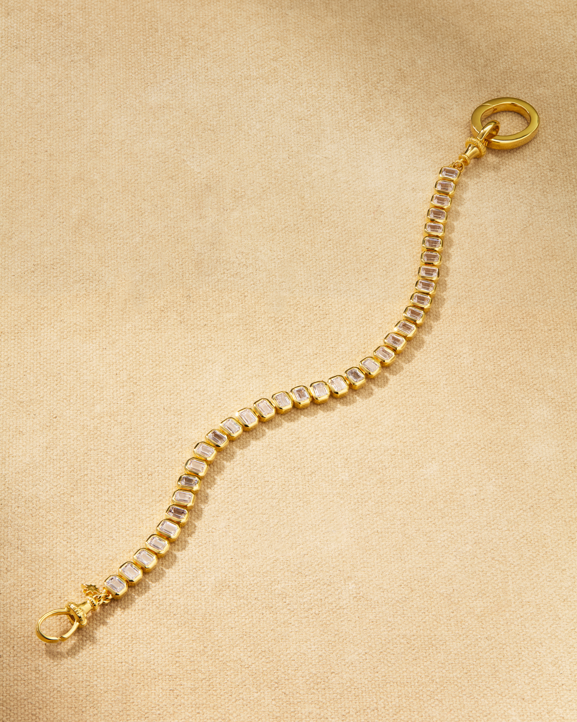 Etta tennis bracelet in gold with emerald cut crystals and oval clasp, designed for layering and multiway styling
