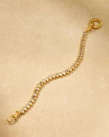 Etta tennis bracelet in gold with emerald cut crystals and oval clasp, designed for layering and multiway styling