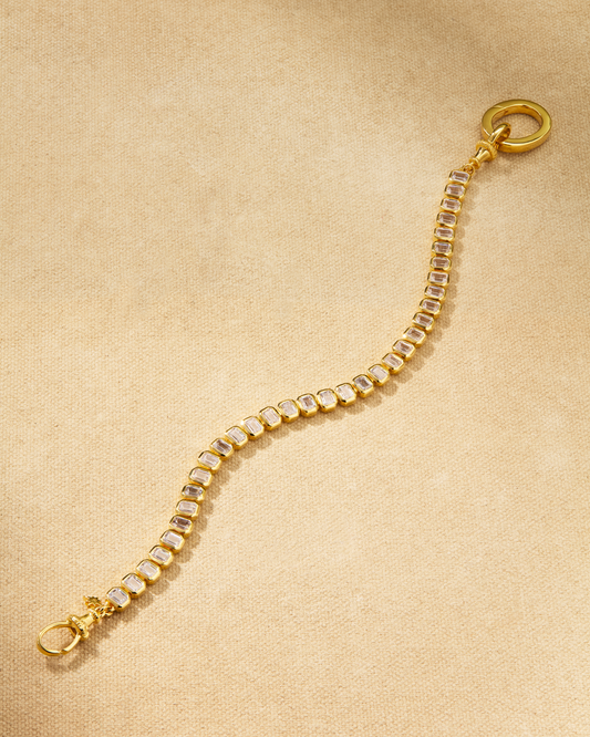 Etta tennis bracelet in gold with emerald cut crystals and oval clasp, designed for layering and multiway styling
