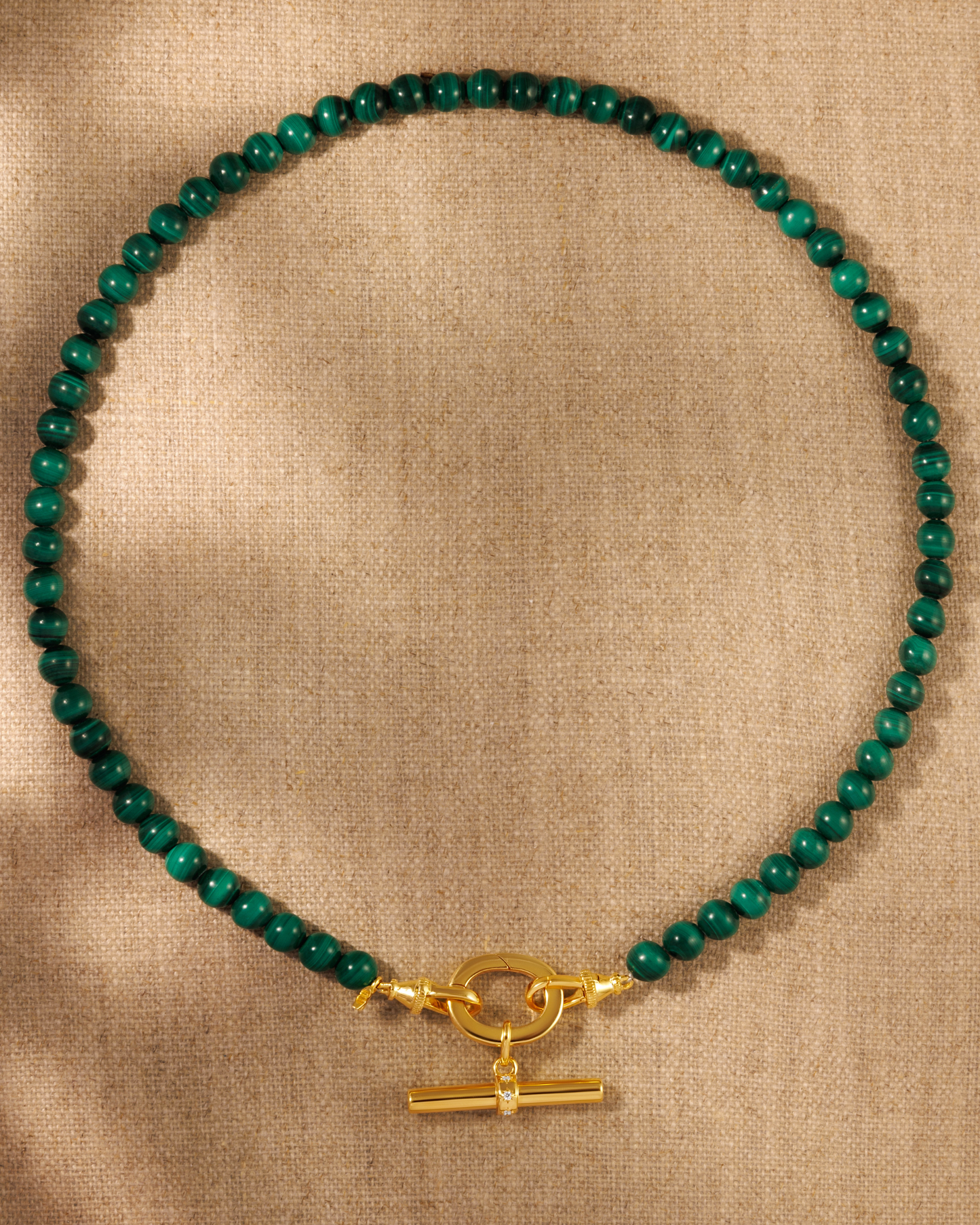 Malachite bead necklace with gold T-bar pendant on antique inspired clasp