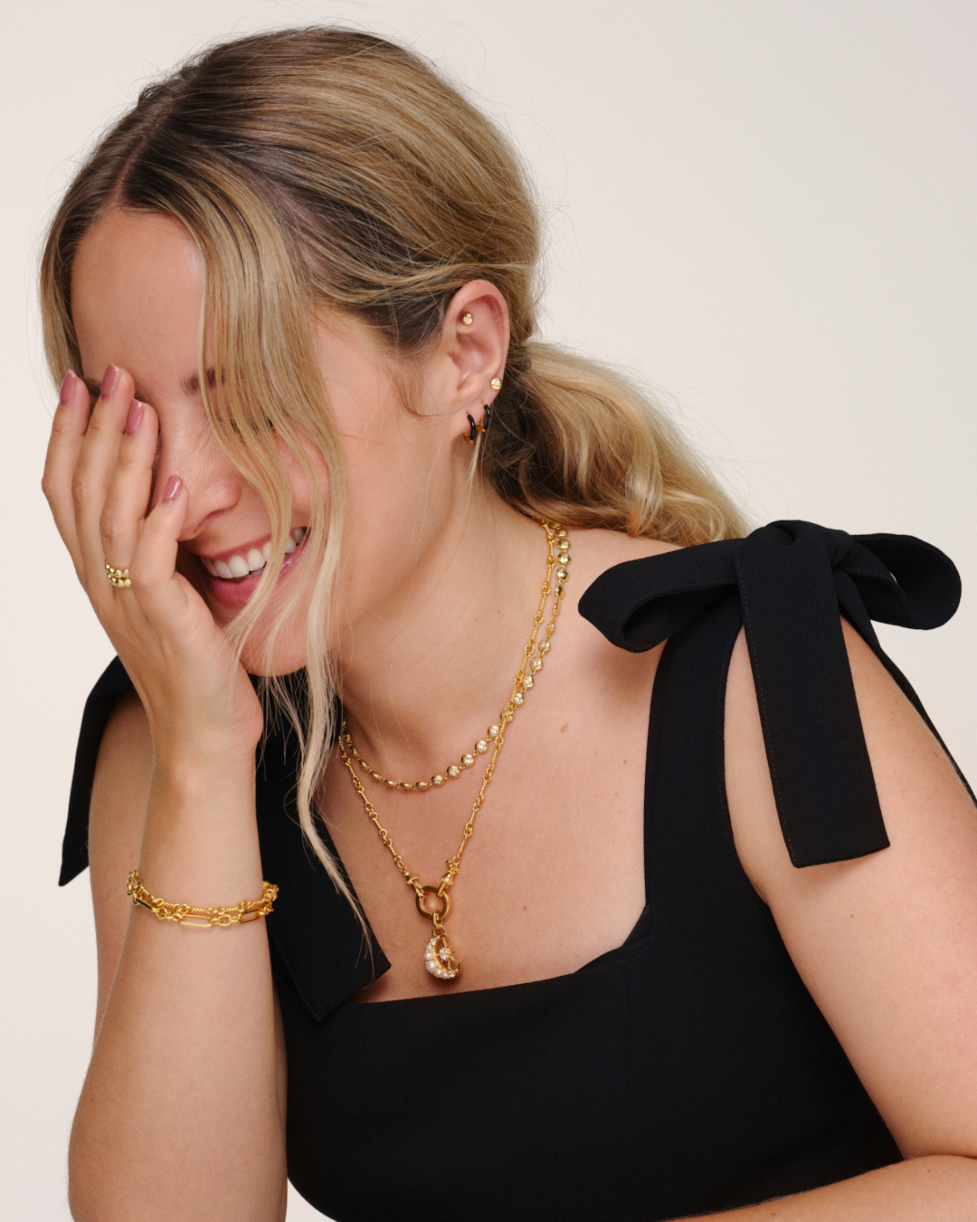 Fleur de Force wearing gold layered necklaces with Lulu tennis chain, Arabella chain and Luna pendant styled together with matching bracelet