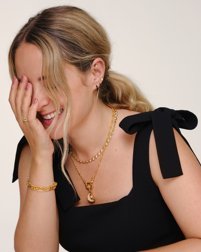 Fleur de Force wearing gold layered necklaces with Lulu tennis chain, Arabella chain and Luna pendant styled together with matching bracelet