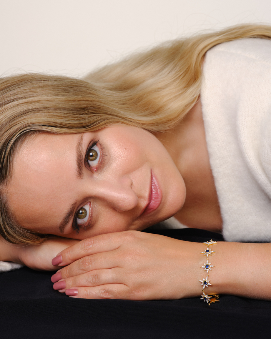 Fleur de Force  wearing a sapphire blue crystal bracelet with a gold-plated brass chain and antique-inspired lobster clasps