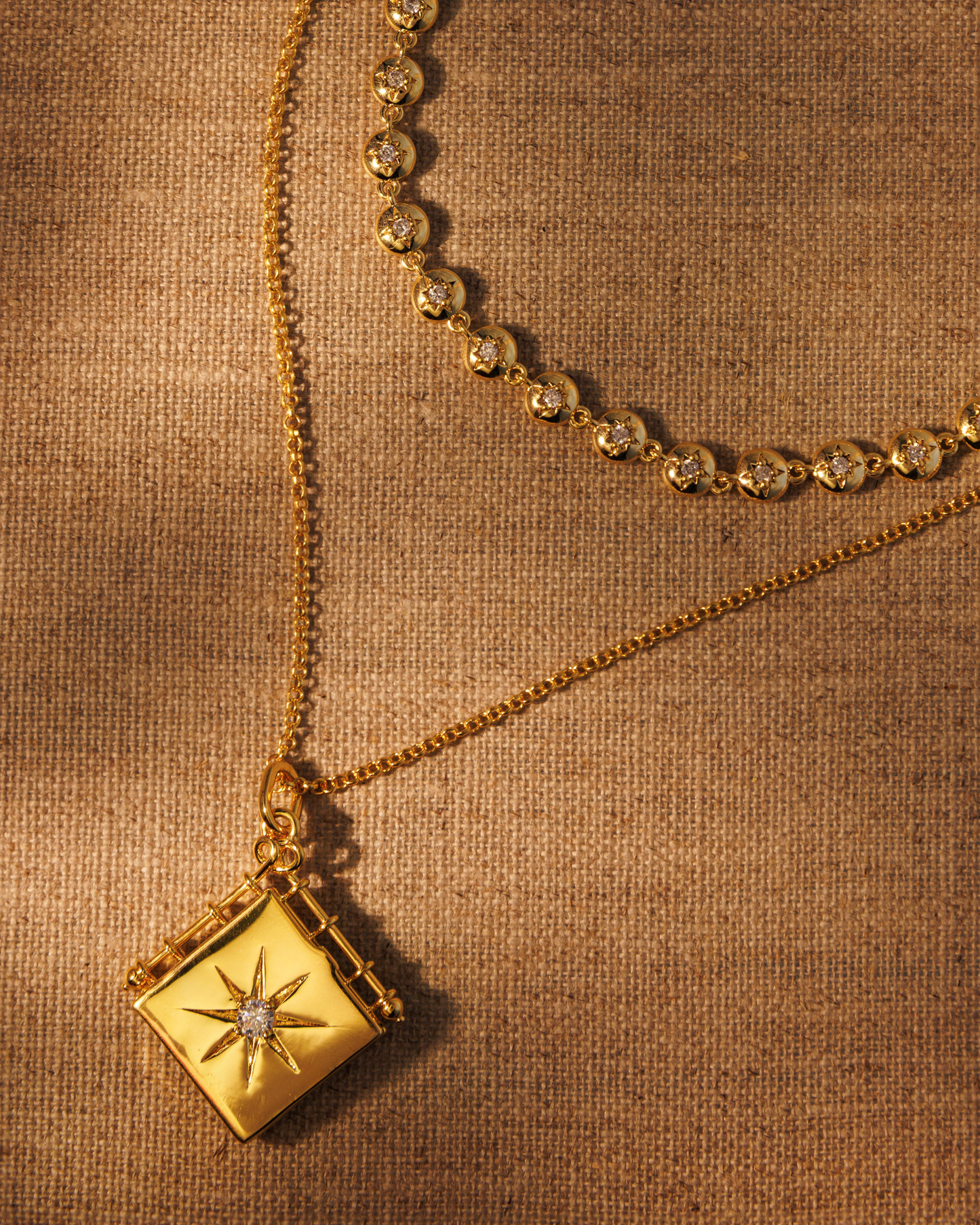 Raven James OLIVIA gold book locket pendant on LONG IVY fine chain stacked with LULU star-set chain, 18ct gold plated engravable locket layering set with antique-inspired star motif and central crystal