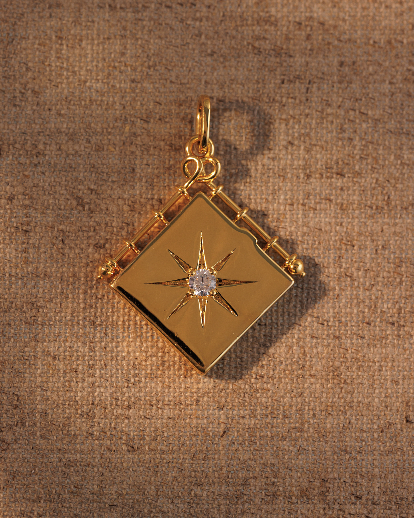 Raven James OLIVIA gold book locket pendant, 18ct gold plated recycled brass engravable book locket with antique-inspired star motif and central crystal
