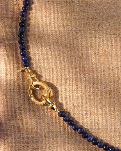 Close-up of lapis beads with gold clasp and oval ring