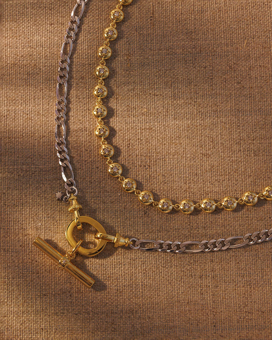 Layered gold and silver necklace set with T-bar pendant and crystal link chain