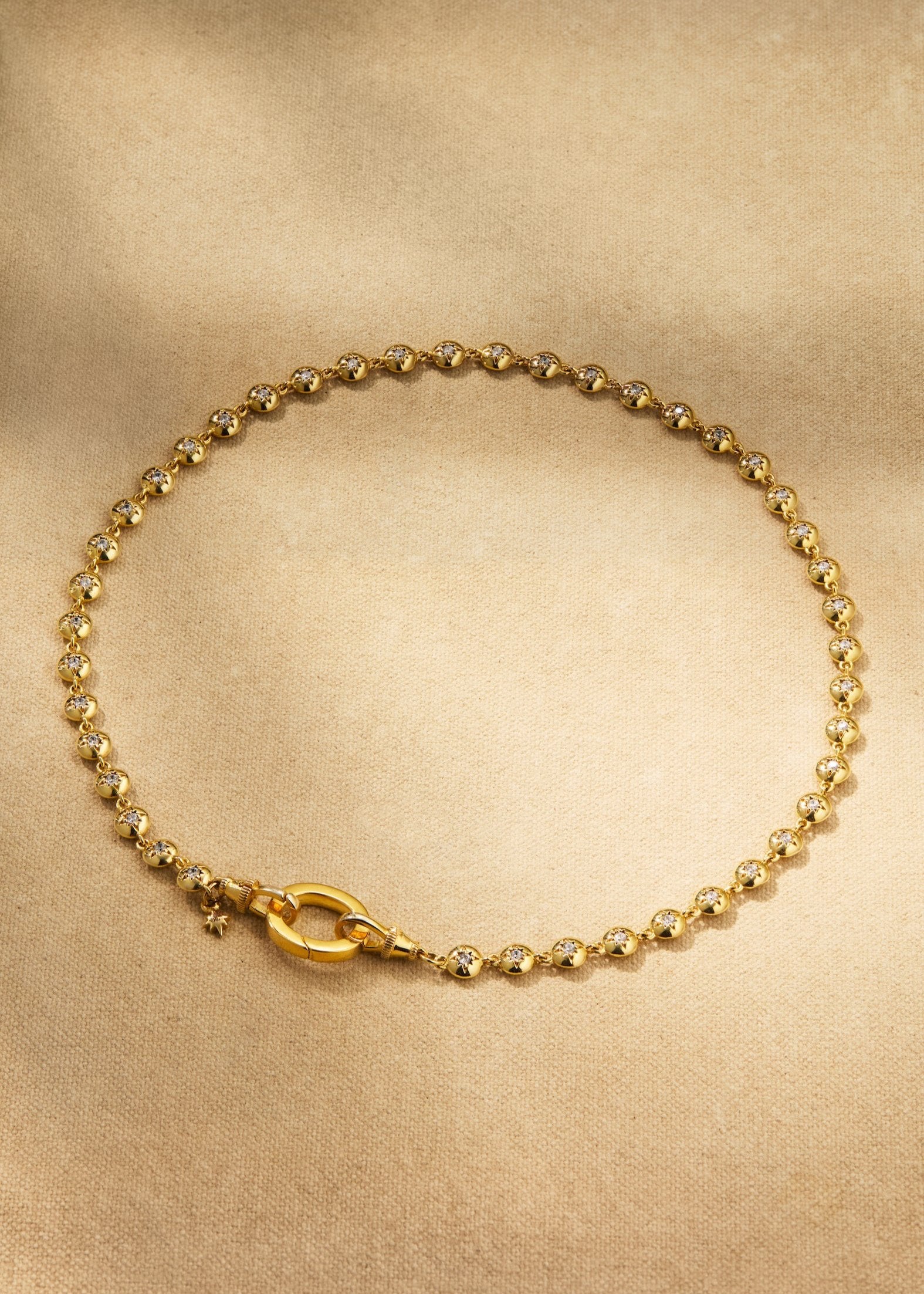 Gold button link necklace with round crystal details
