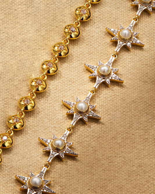 gold tennis bracelet with crystals and pearl bracelet with star detailing styled together as stack or multiway necklace