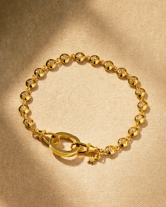Gold tennis bracelet with crystal details and oval clasp for layering and multiway styling