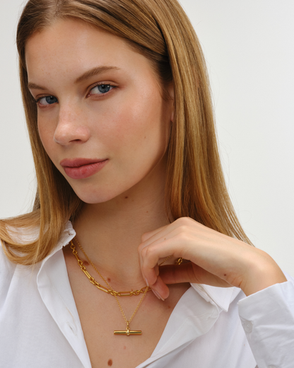 Layered gold necklaces featuring Lucy T-bar pendant on Ivy chain with Tabitha chain