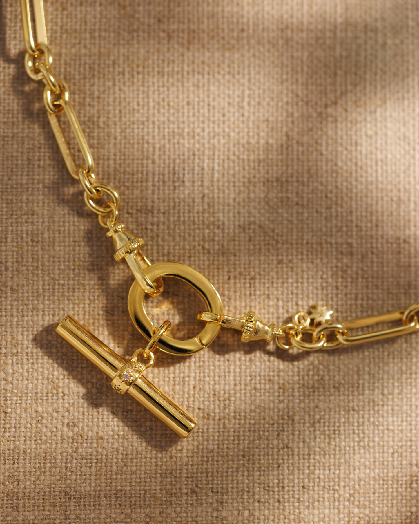 Lucy gold T-bar pendant with crystal stars on Tabitha paperclip chain necklace