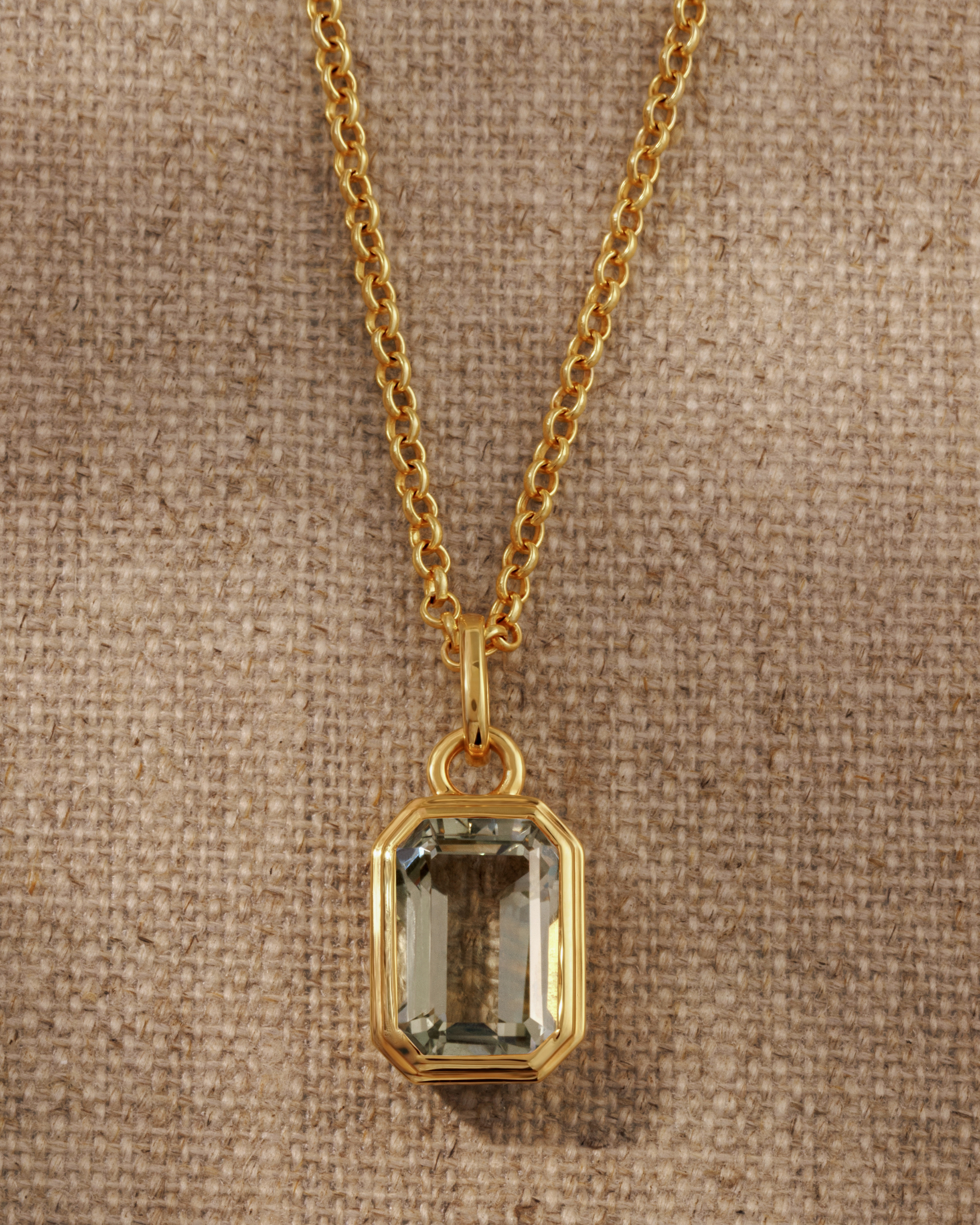 Lumi 18ct gold plated emerald cut green amethyst pendant styled on a gold chain necklace