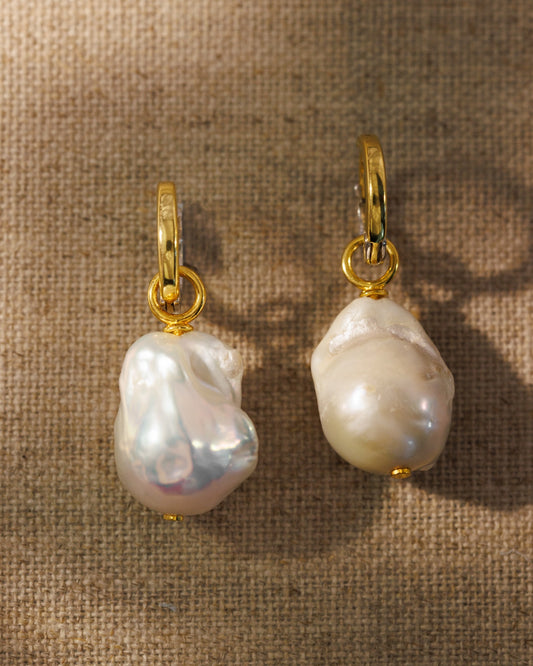 Reversible gold huggies with baroque pearl charms. Two hoops, two finishes, endless ways to style. Demi-fine, made to layer.