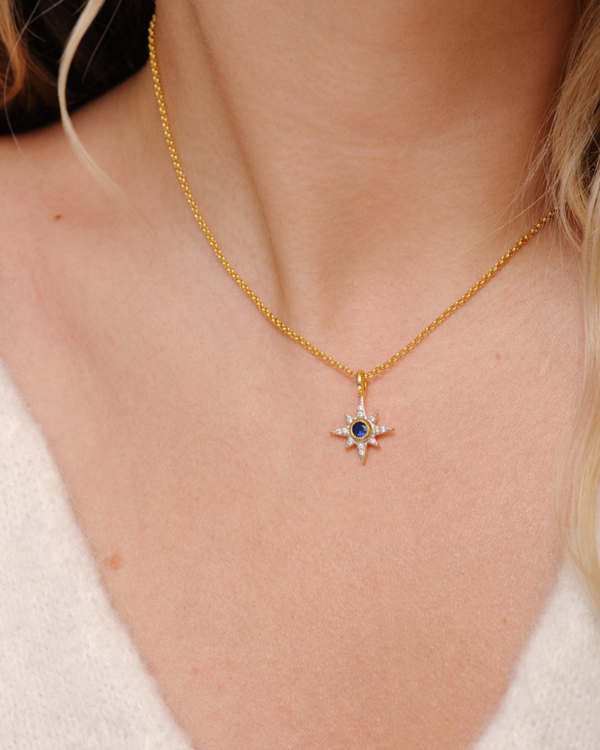North Star pendant necklace in gold with sapphire blue stone, oval clasp and layering styling