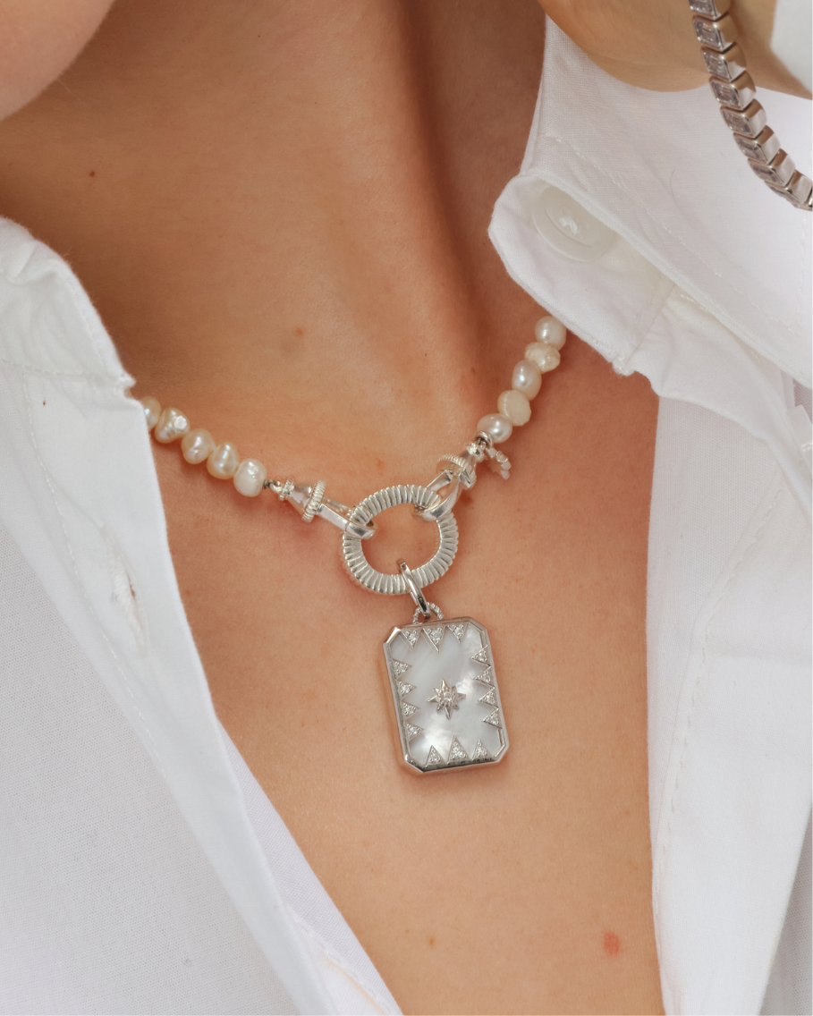 Octavia reversible pendant in solid silver with mother of pearl backplate and north star cubic zirconia design styled with Aura baroque pearl