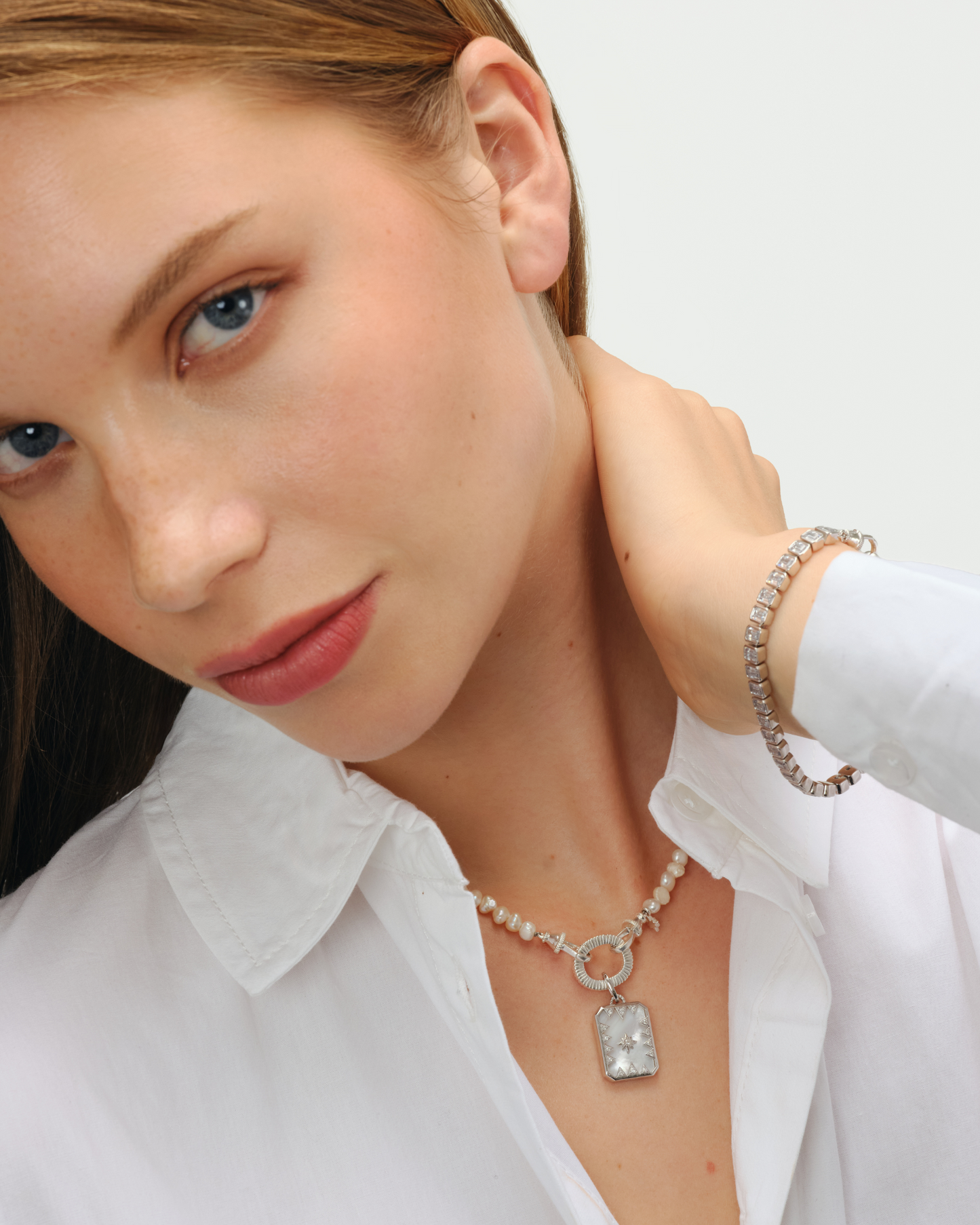 Octavia reversible pendant in solid silver with mother of pearl backplate and north star cubic zirconia design styled with Aura baroque pearl 
