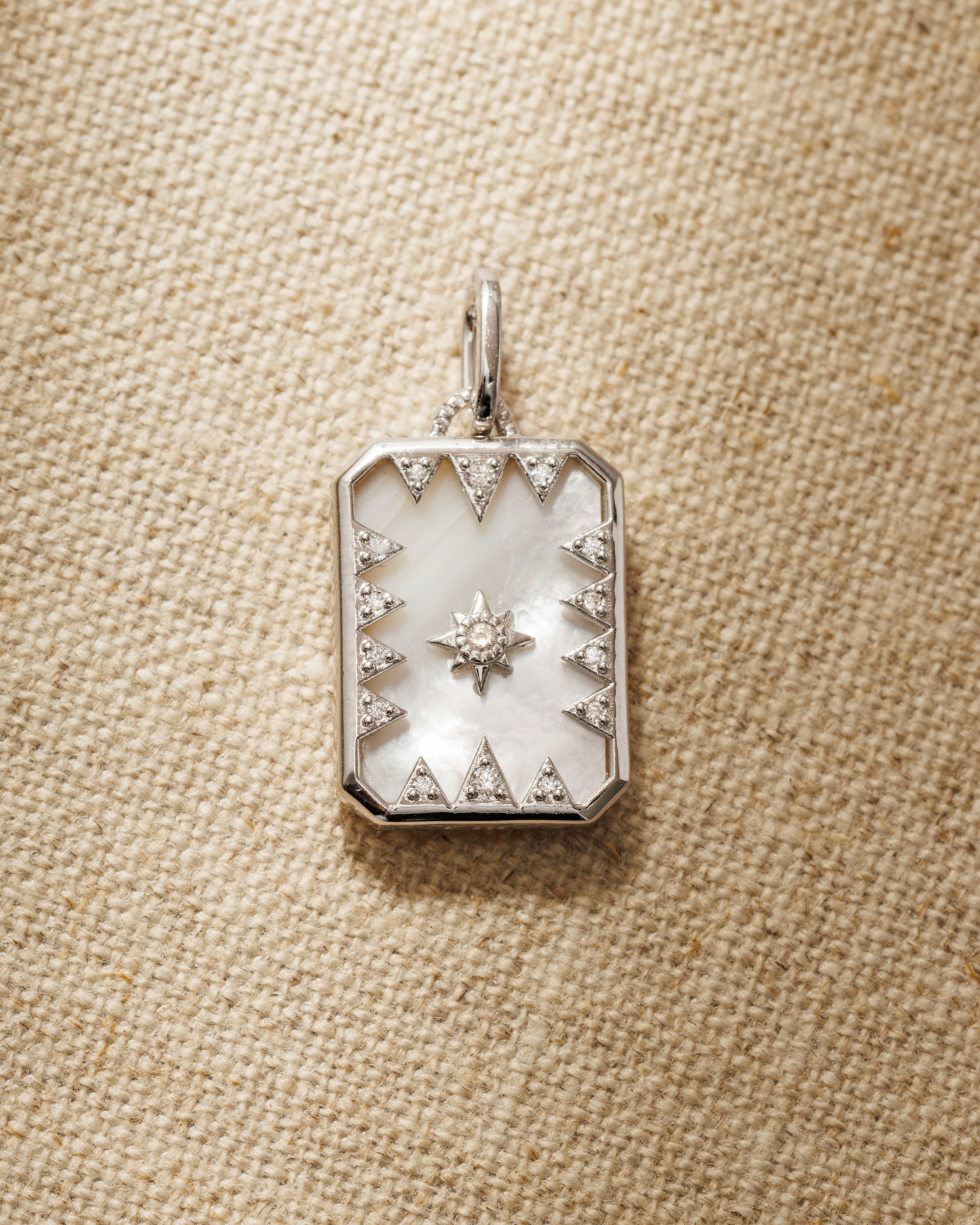 Octavia reversible pendant in solid silver with mother of pearl backplate and north star cubic zirconia design