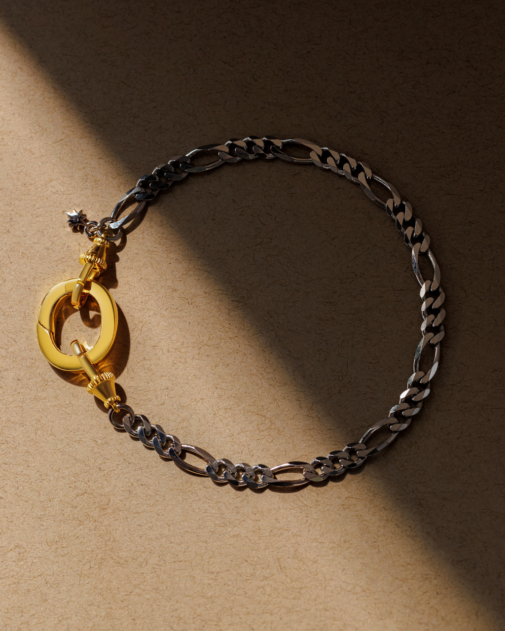 Mixed metal figaro chain bracelet with gold oval clasp and dual lobster clasps in silver and gold