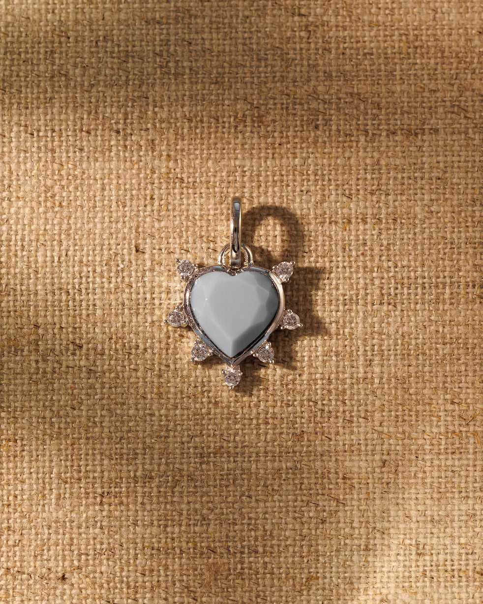 Pale blue opal heart pendant in a silver crystal-edged sunburst halo, Raven James.