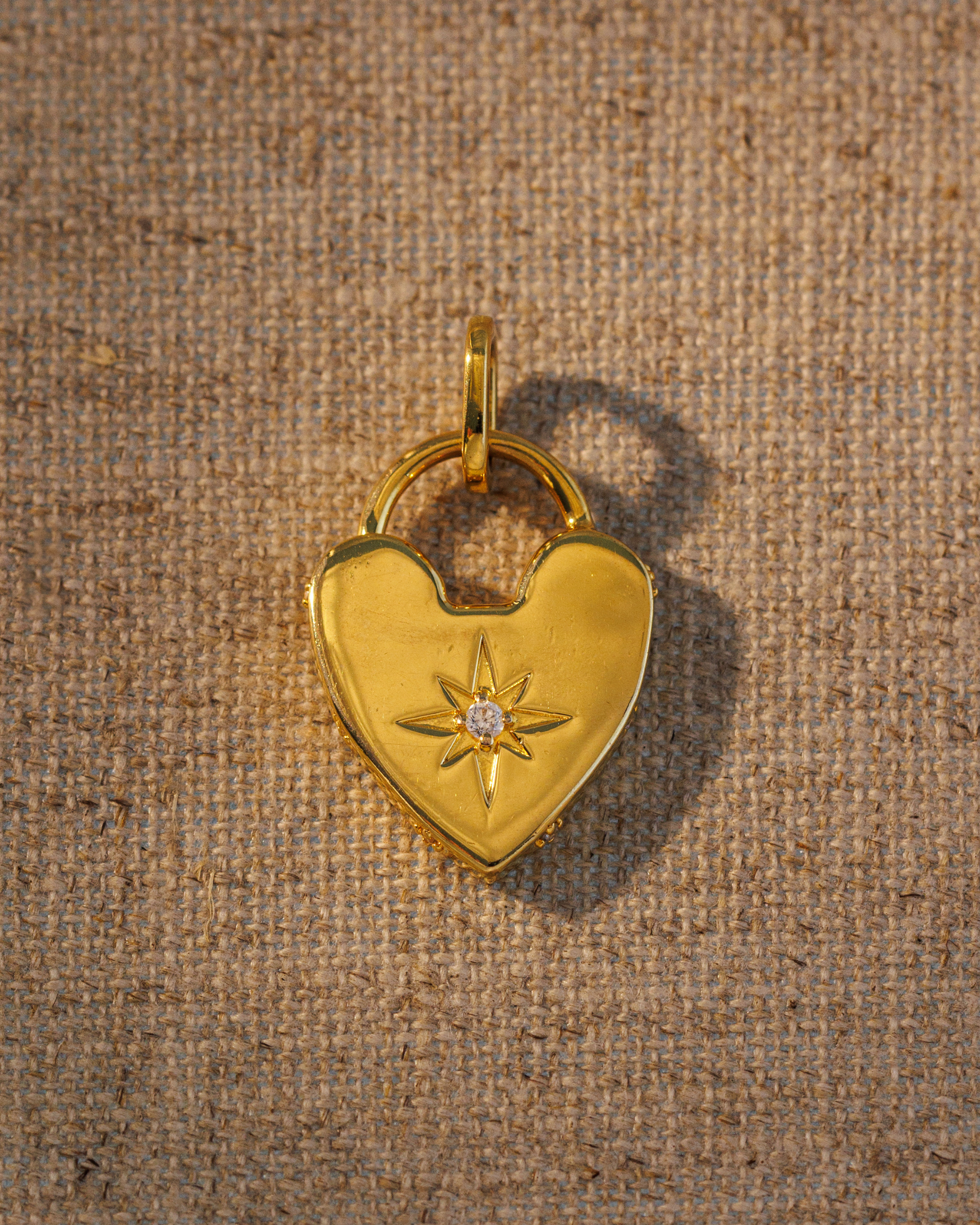 Raven James ROMY gold heart pendant, 18ct gold plated recycled brass engravable heart pendant with antique-inspired star motif and central crystal