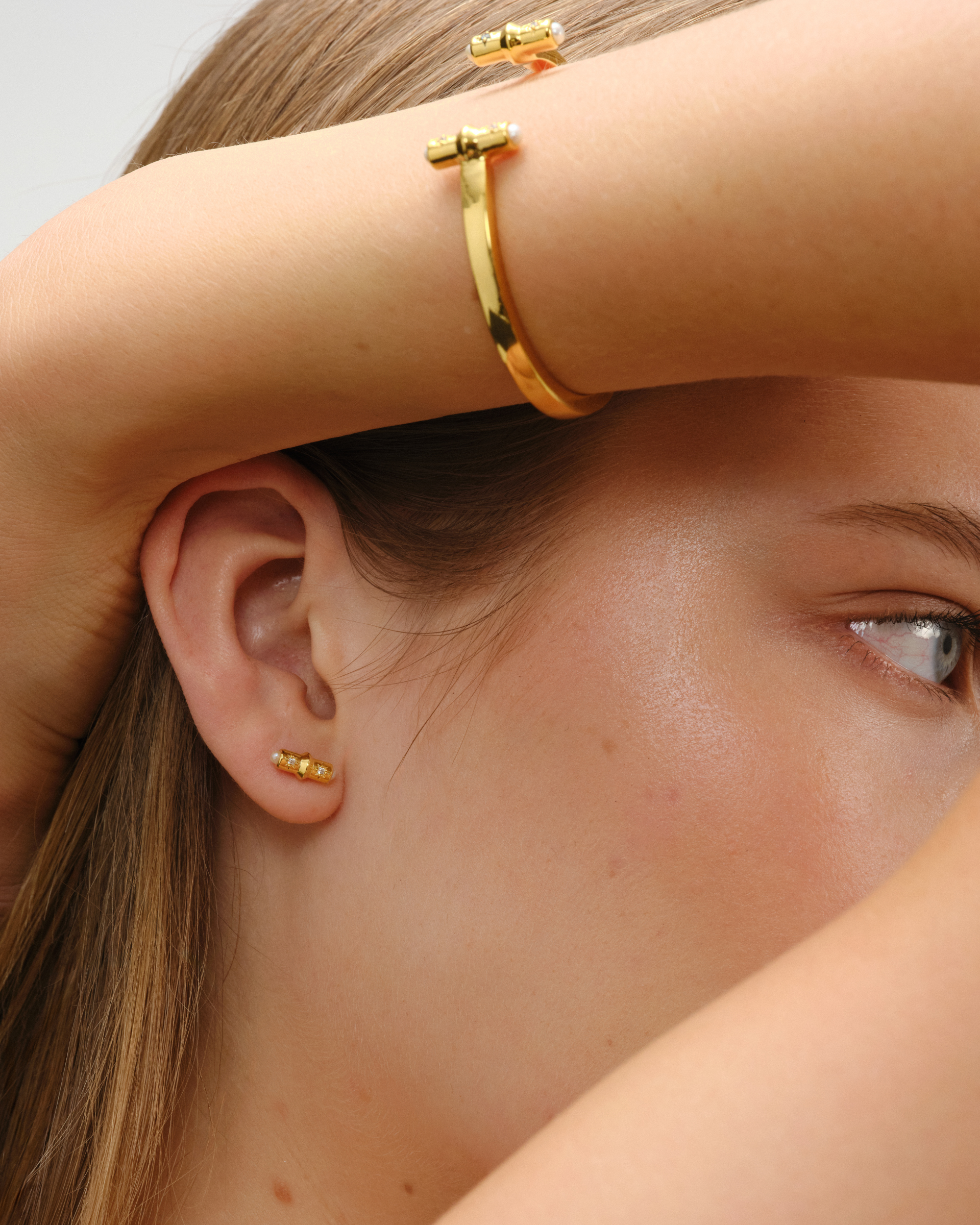 Gold open cuff bracelet with T-bar ends, crystals and pearl detail