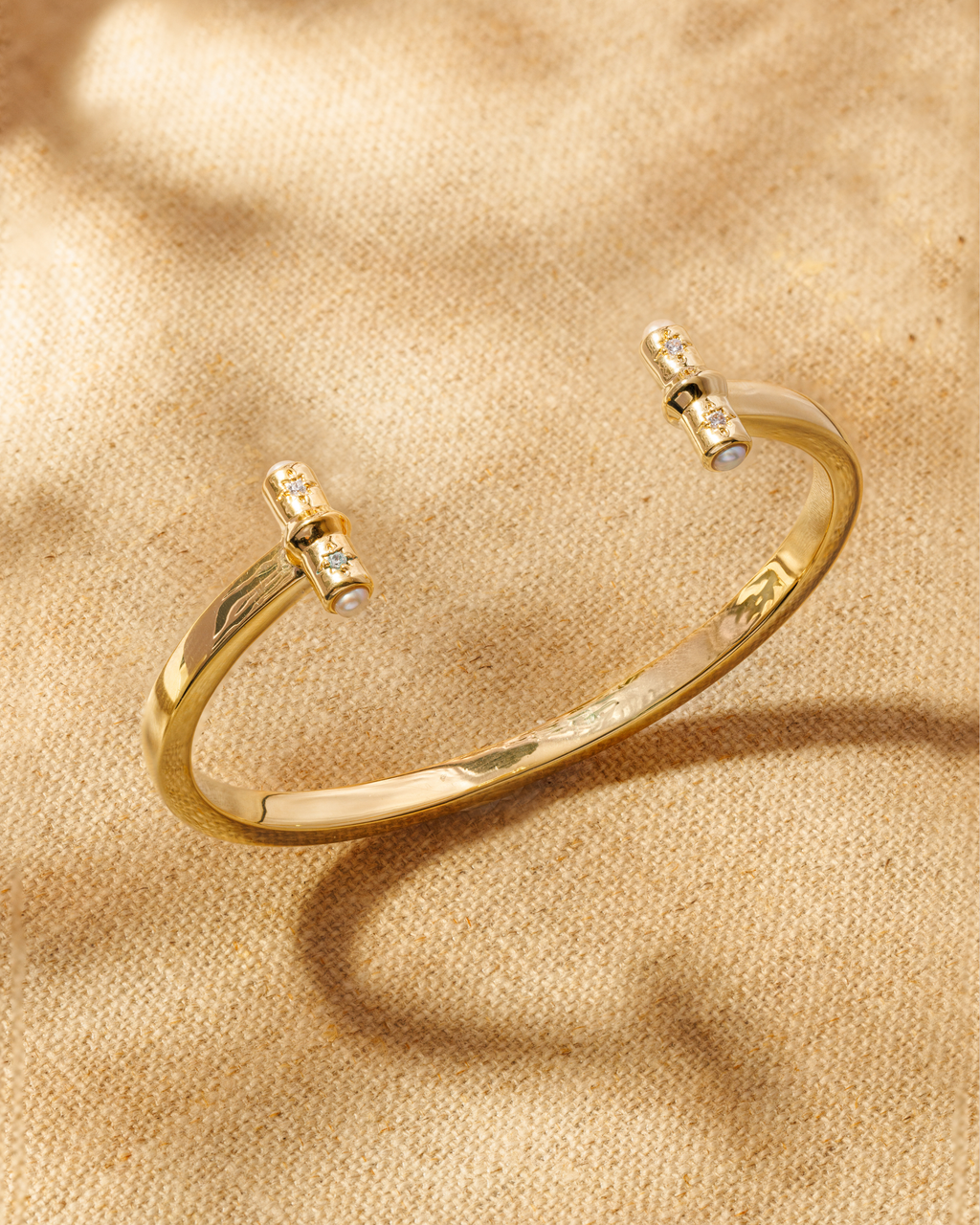 Gold open cuff bracelet with T-bar ends, crystals and pearl detail