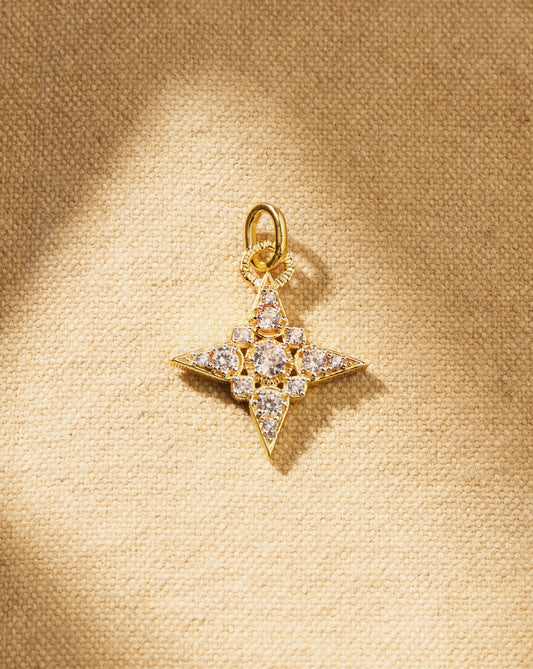 Antique-inspired star charm with white crystals and gold setting