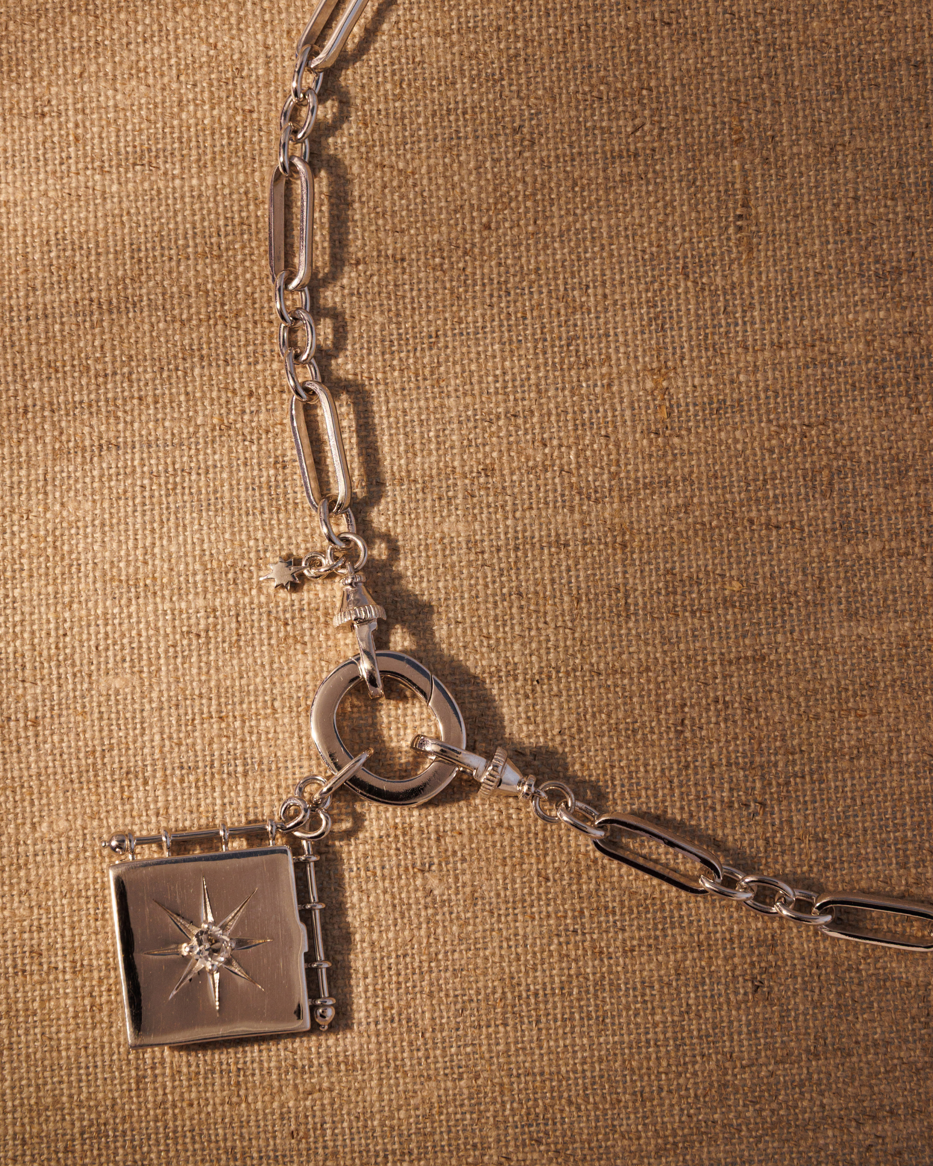Raven James OLIVIA silver book locket pendant on TABITHA paperclip chain necklace, recycled 925 sterling silver engravable locket set with antique-inspired star motif and central crystal