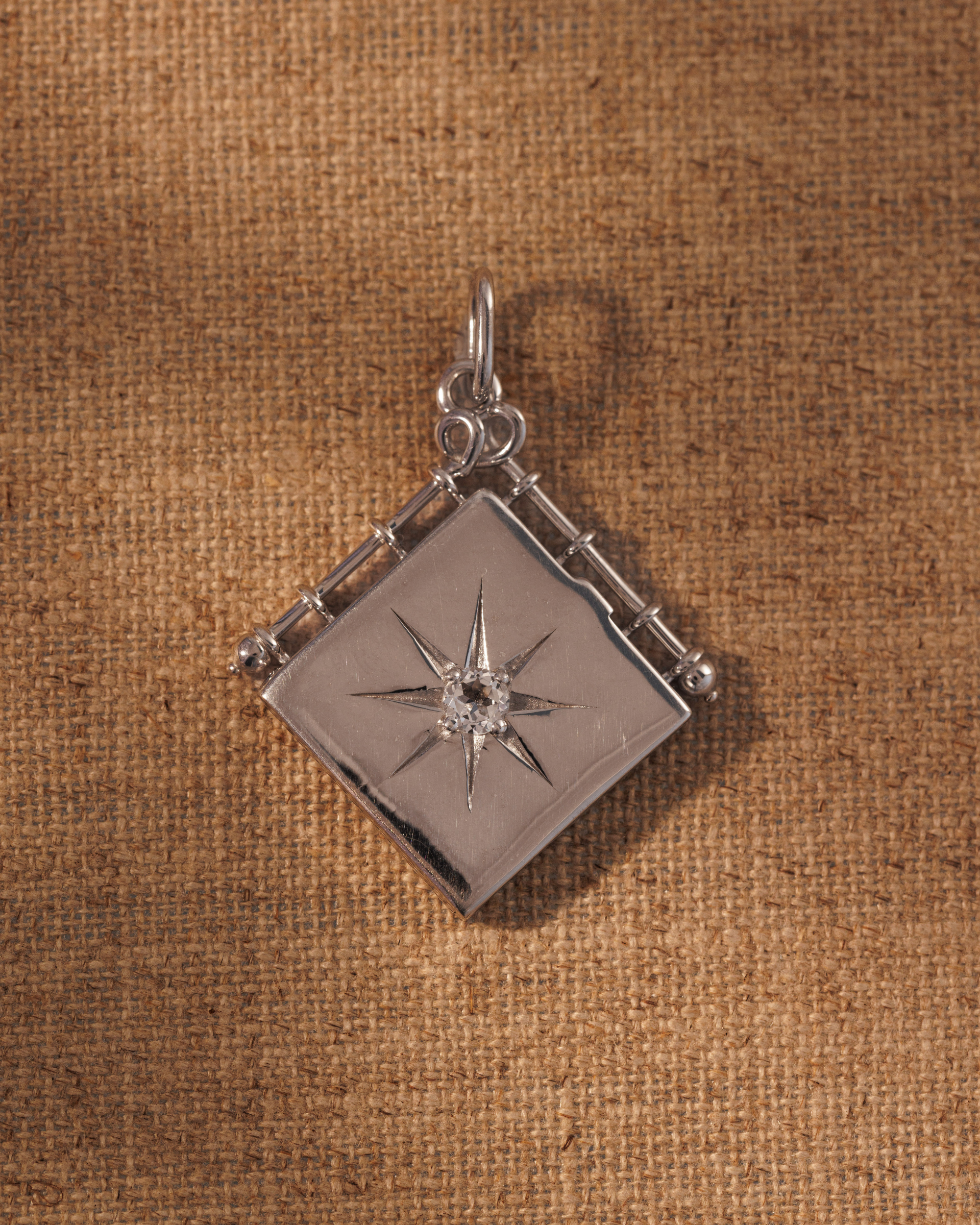 Raven James OLIVIA silver book locket pendant, recycled 925 sterling silver engravable book locket with antique-inspired star motif and central crystal