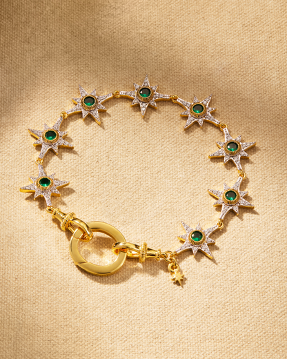 Supernova bracelet in gold with emerald green crystals and star detailing, designed with oval clasp for multiway styling