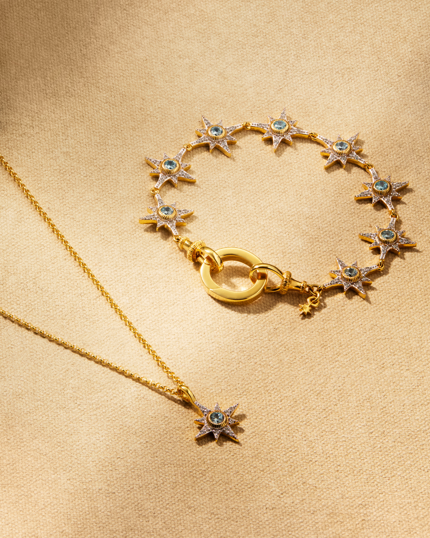 Supernova aqua bracelet and North Star pendant necklace in gold with aqua crystals styled together with oval ring multiway jewellery