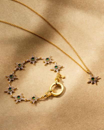 Gold bracelet and pendant necklace with emerald green crystals and star design layered multiway jewellery styling