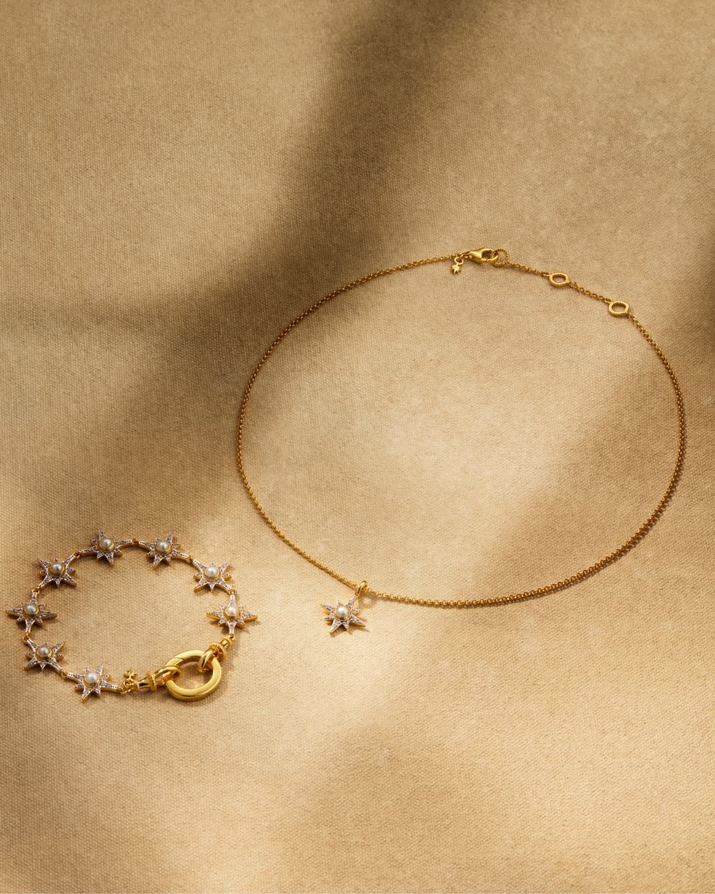 Supernova pearl bracelet and North Star pendant necklace in gold with pearl and crystals styled together with oval ring multiway jewellery