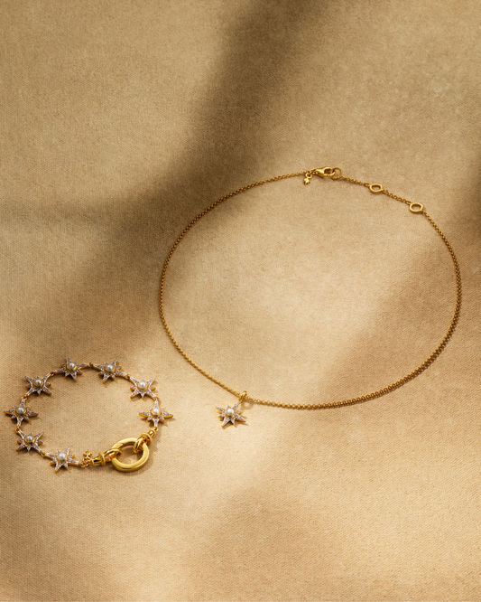 Supernova pearl bracelet and North Star pendant necklace in gold with pearl and crystals styled together with oval ring multiway jewellery