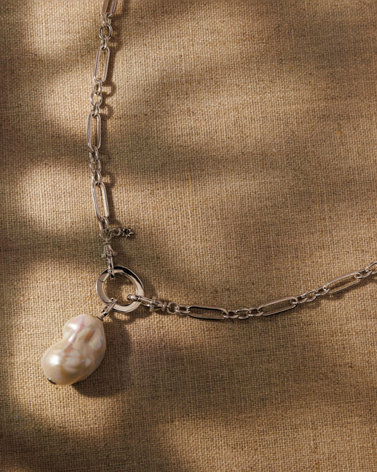 Silver paperclip chain and baroque pearl pendant. Antique-inspired demi-fine jewellery, built to layer, swap and wear your way.