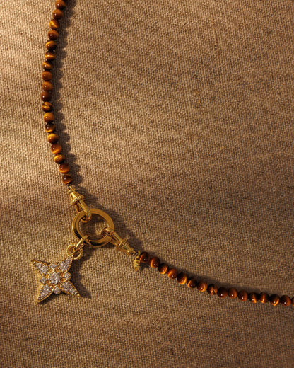 Tiger’s eye beaded necklace with gold crystal star pendant attached to oval clasp layered jewellery styling