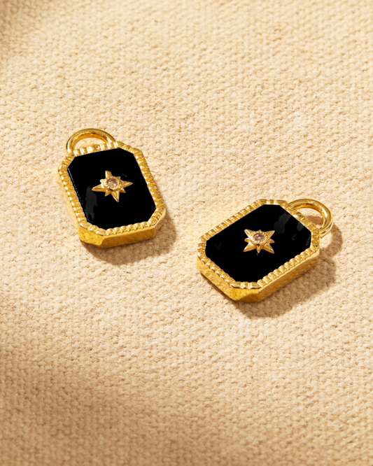Tavi earring charms in gold with black onyx and crystal star detail, designed to attach to hoop earrings