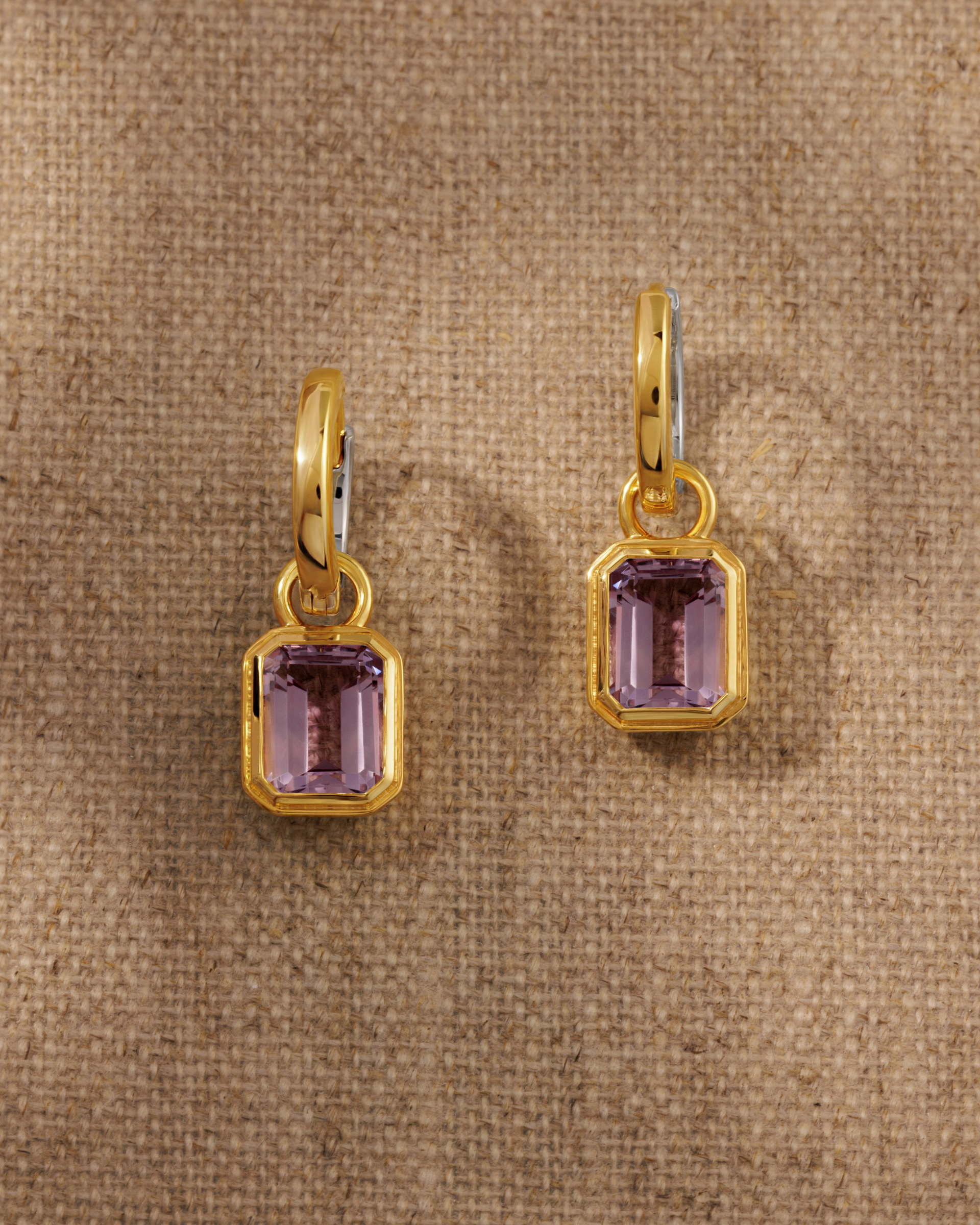 Cara reversible huggie hoop earrings styled with Lumi emerald cut pink amethyst charm in 18ct gold