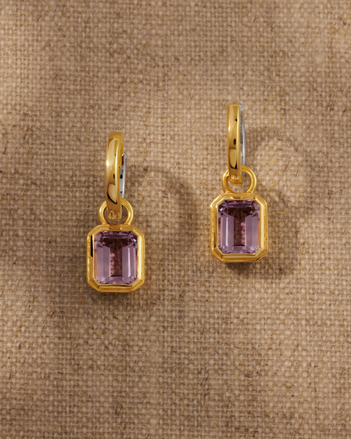 Cara reversible huggie hoop earrings styled with Lumi emerald cut pink amethyst charm in 18ct gold