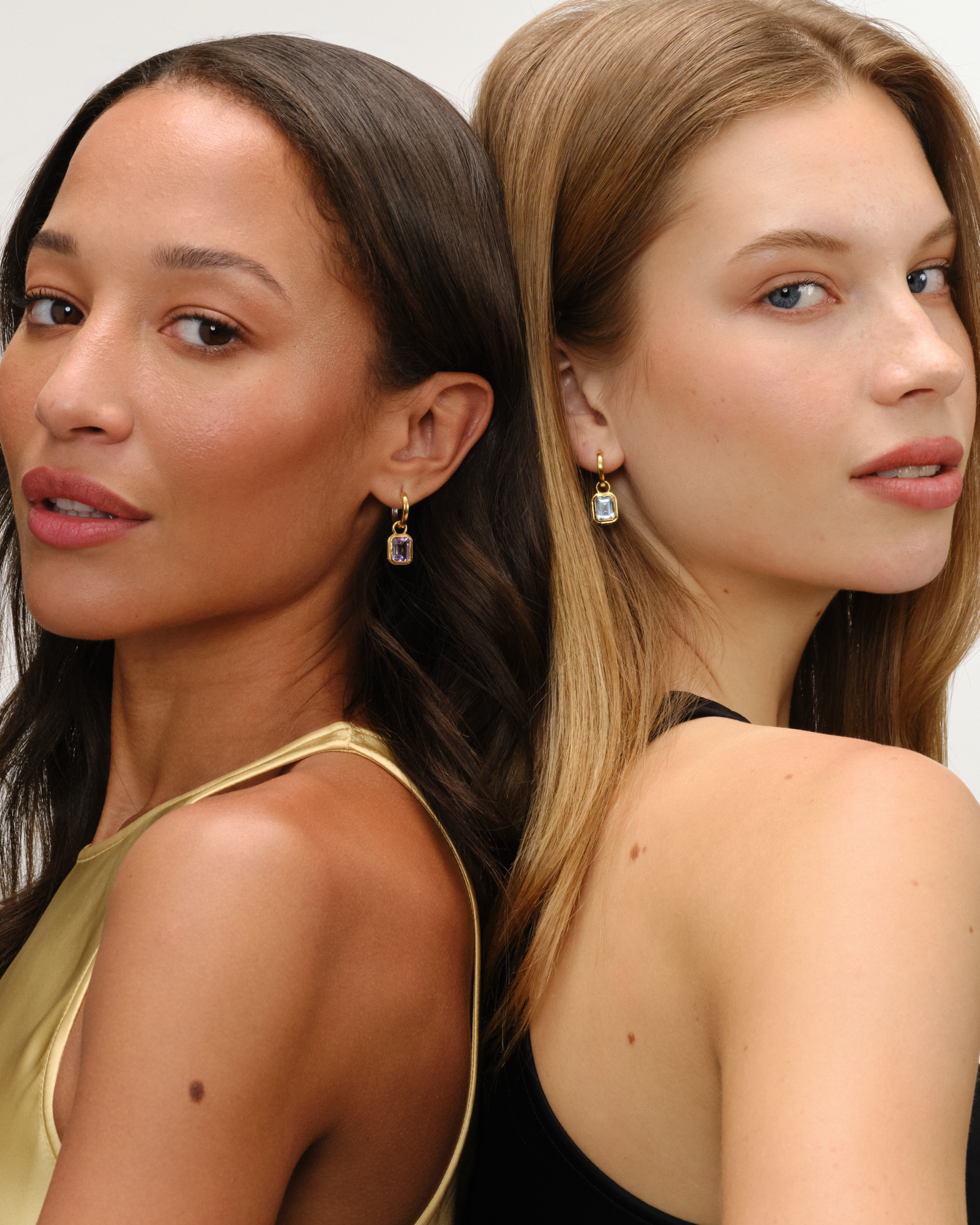 Cara reversible 18ct gold and silver hoop earrings styled with Lumi emerald cut pink amethyst and blue topaz drop charms